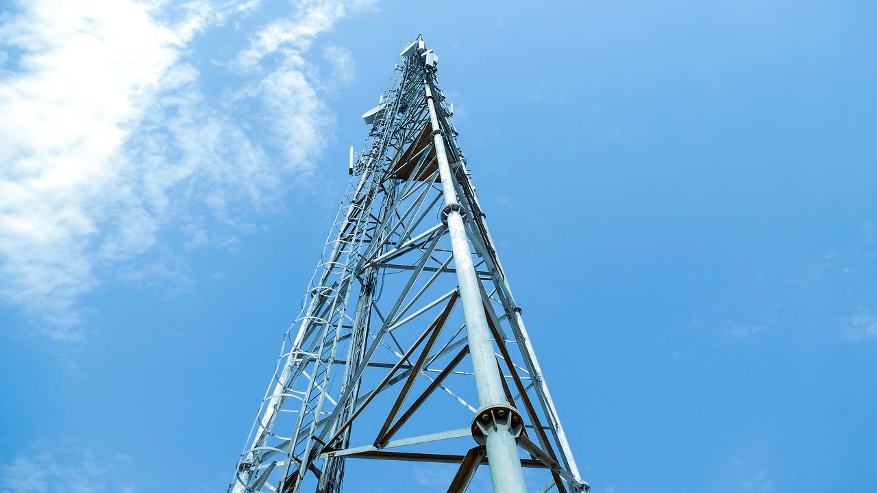 A view of a tall cell tower from below.